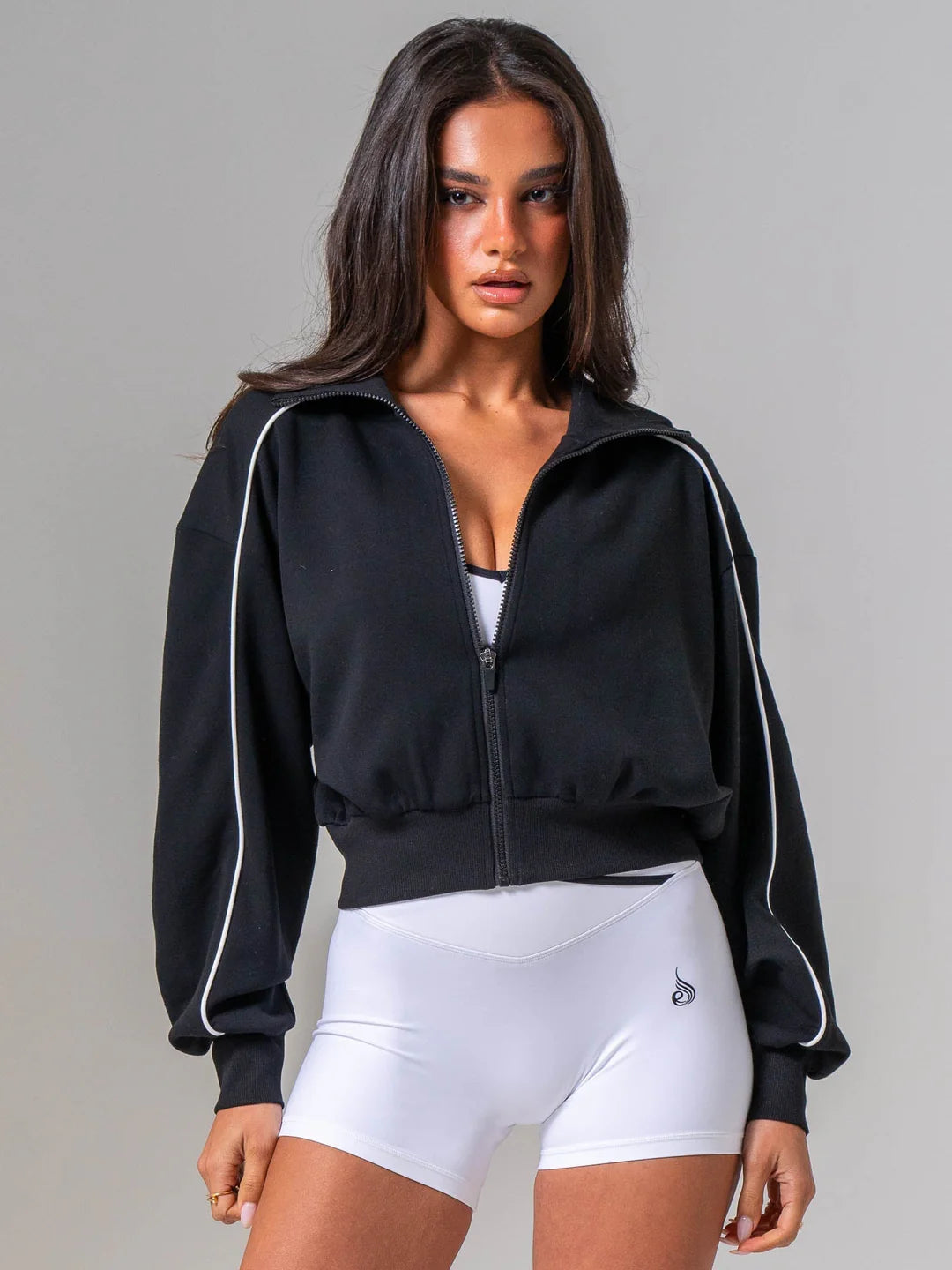 Ryderwear model wearing a black and white contrast track jacket